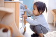 © Dasha Petrenko - A little Asian girl is playing in the bedroom at home. A cute Korean baby in a kindergarten.