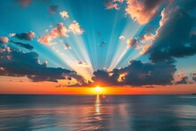 Breathtaking Sunset With Sun Rays Piercing Through Clouds Over The Ocean, Creating A Dramatic Skyscape
