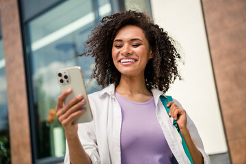 Sticker - Photo of cute good mood lady wear white shirt backpack recording video modern device walking university outside urban city street