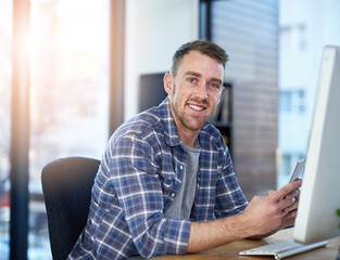 Phone, computer and portrait of creative businessman in office with opportunity, confidence and tech startup. Web design, pride and happy face of online developer with professional career at agency