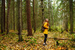 © maxbelchenko - Happy female tourist walk in the autumn forest. Nature. Trips. Active lifestyle.