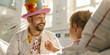 Young volunteer dressed as clown doctor visiting sick child in a hospital to help in lifting patients mood with the positive power of hope and humor.