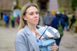 Portrait of a happy woman looking to side while holding and carrying it in a baby carrier