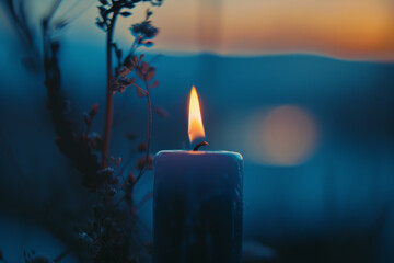 Canvas Print - A candle is lit in a dark room with a view of the mountains in the background