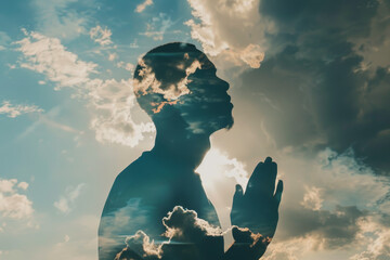 A person praying in front of a cloudy sky