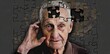 A doctor is placing puzzle pieces on the head of an older man. Alzheimer's concept, Memory loss due to dementia