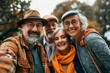 © Loli - Group of senior friends taking a selfie in the park. Group of elderly people taking a selfie outdoors.