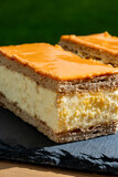 Fototapeta Kuchnia - Celebration of the King birthday in Netherlands, tompoes or tompouce, iconic pastry in Netherlands made from puff dough, orange icing, cream