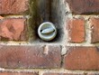 old, vintage bakelite light switch on brick wall
