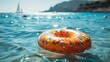 Whimsical Encounter: Inflatable Donut Drifting With Sailboat on Ocean