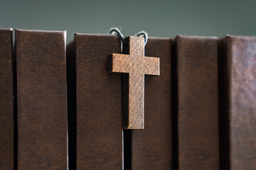 Wall Mural - Necklace with wooden cross on books, Christian concept, religious symbol