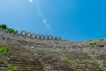 Wall Mural - Picturesque ruins of an amphitheater in the ancient city of Perge, Turkey. Perge open-air museum.