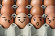 Close up view of organic fresh chicken eggs in paper cardboard tray packaging with various happy faces.