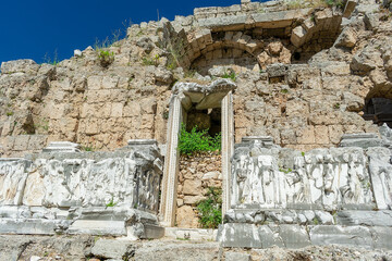 Wall Mural - Picturesque ruins of an amphitheater in the ancient city of Perge, Turkey. Perge open-air museum.