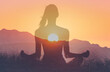 Woman in yoga pose, zen meditation at sunset.
