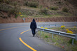 Moroccan man dressed in djellaba walking down the road