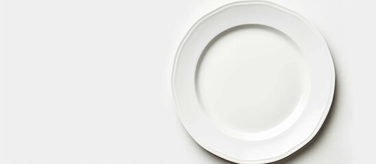 Wall Mural - An empty plate pictured against a white background. Seen from a top-down perspective.