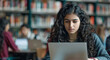© Peopleimages - AI - Laptop, reading and woman in university library studying for exam, assignment or test online. Education, technology and female student working on college project with computer in classroom at campus.