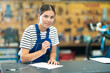 Young woman bicycle repair service worker in uniform signs agreement
