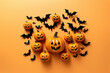 A cluster of pumpkins on the ground with bats circling them in the air