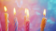 Rainbow birthday candles on colorful background