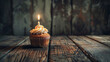 Birthday concept with cupcake and candles on wooden background