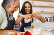 © Wavebreak Media - Asian grandmother and biracial teenage granddaughter are cooking together at home