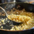 minced garlic being sautéed in the melted butter in the skillet
