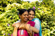© Wavebreak Media - Indian mother and daughter in traditional attire, embracing outside