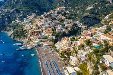 Wall Mural - Aerial view of Positano with comfortable beach and blue sea on Amalfi Coast in Campania, Italy. Positano village on the Amalfi Coast, Salerno, Campania. Beautiful Positano, Amalfi Coast in Campania.