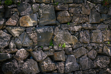 Poster - Granite stones of different shapes and colors. Wall cladding.