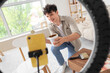 © Pixel-Shot - Male blogger with brush painting furniture while recording video at home