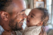 Close up of a new dad holding their young baby. Fatherhood and fathers day concepts