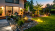 Cozy country garden with solar illuminated paths and decorative stones,Family house patio and green lawn of the front yard in suburban area of Vancouver,House terrace illuminated by lights 
