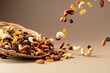 Flying dried fruits and nuts on a beige background.