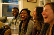 © KirKam - Group of friends laughing together during a casual home gathering, showcasing joy, diversity, and genuine connection.