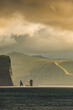 Faroe Islands, Eysturoy island. Cover page with gorgeous sunset over Risin og Kellingin rock pillars. Fjords landscape and seascape.