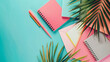 Notebooks stationery supplies and palm leaf on color b