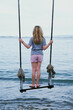 Young Girl Standing on A Swing on a Beach in Bali, Indonesia