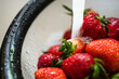 Washing Strawberries with Running Water in Colander