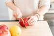 Close-Up of Woman Slicing an Apple on Cutting Board