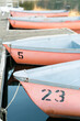 Rowboats lined up at dusk, numbered and tranquil