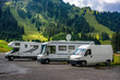 Camper van and motorhomes parked on a mountain landscape