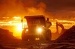 A dramatic scene with a caterpillar digger silhouetted against the orange light of sunrise or sunset, creating a striking industrial landscape