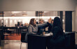 © Flamingo Images - Businesswomen high-fiving during a meeting together in a hotel lobby