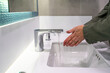 Hands Washing Hands Under Modern Faucet Close up.