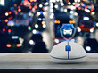 Car with shield flat icon on wireless computer mouse on wooden table over blur colorful night light traffic jam road in city, Business automobile insurance online concept