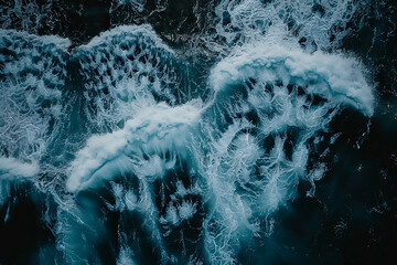 Wall Mural - top view of ocean waves, photo taken from above, drone shot, dark blue water, splashes, white foam, rough sea, rocks in the distance, unsplash photography style,