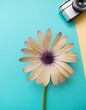 petite fleur sur fond de papier de couleur avec un petit appareil photo en ia