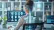 © antkevyv - Ergonomic concept, woman working with x-ray image of her spine on screen, human skeleton medical scan office stethoscope computer monitor